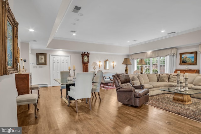 living room with crown molding, recessed lighting, wood finished floors, and visible vents
