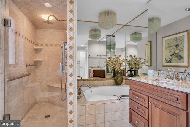 full bathroom featuring vanity, a shower stall, and a garden tub