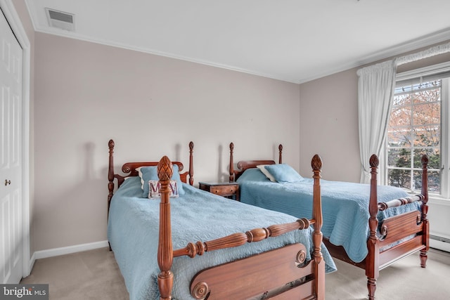 carpeted bedroom with a closet, baseboards, crown molding, and visible vents