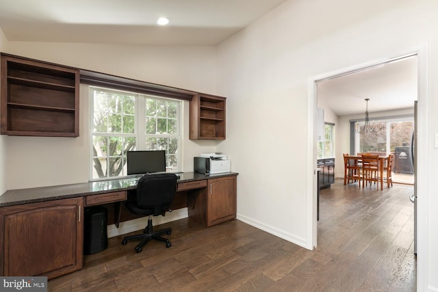 office space with dark wood finished floors, baseboards, a notable chandelier, and vaulted ceiling