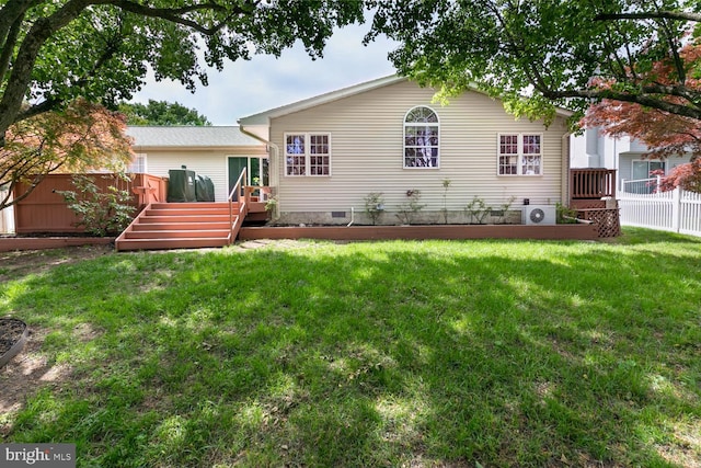 back of property with a deck, ac unit, fence, crawl space, and a lawn
