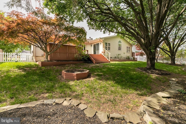 view of yard with a fenced backyard and a wooden deck