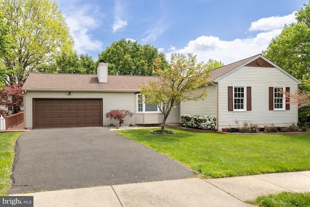 ranch-style house featuring a front yard, a shingled roof, a chimney, aphalt driveway, and an attached garage