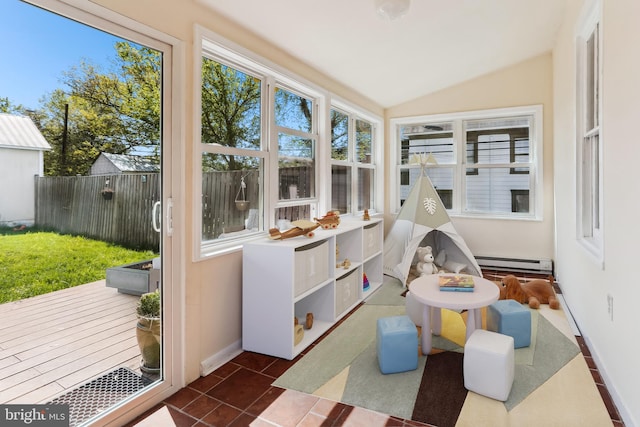 sunroom / solarium with plenty of natural light and a baseboard heating unit