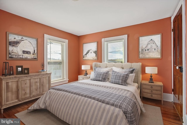 bedroom featuring baseboards and dark wood finished floors