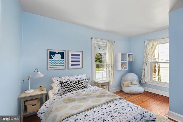 bedroom with baseboards and wood finished floors