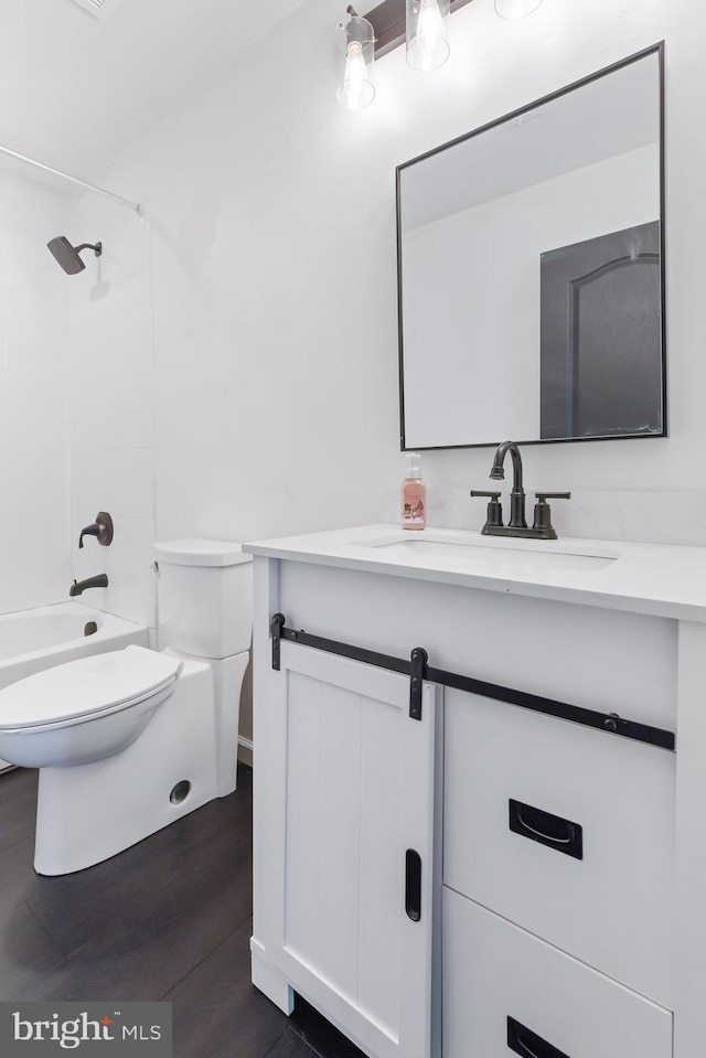 full bathroom featuring wood finished floors, vanity, toilet, and bathing tub / shower combination