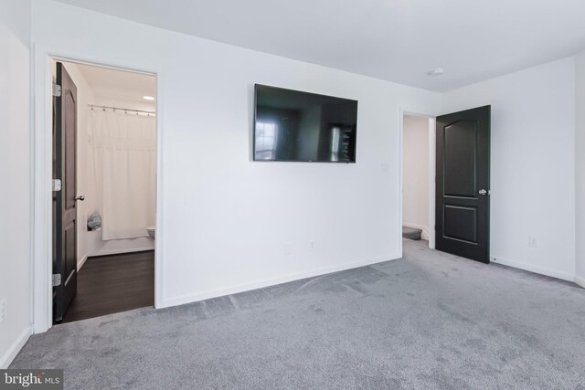 interior space with baseboards and carpet
