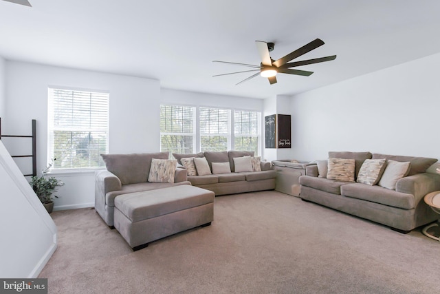 living room with ceiling fan, baseboards, and carpet floors