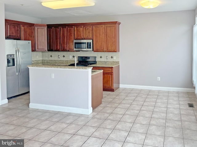 2208 Merion Pond Pond Unit 62, Woodstock, MD 21163 - kitchen with light stone counters, stainless steel appliances, tasteful backsplash, a kitchen island, and visible vents