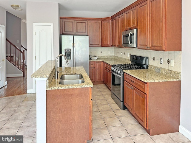 2208 Merion Pond Pond Unit 62, Woodstock, MD 21163 - kitchen featuring a kitchen island with sink, light tile patterned flooring, appliances with stainless steel finishes, and a sink