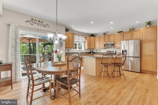 dining room with recessed lighting and light wood-type flooring