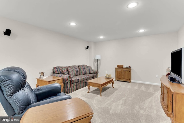 living room featuring recessed lighting, baseboards, and light colored carpet