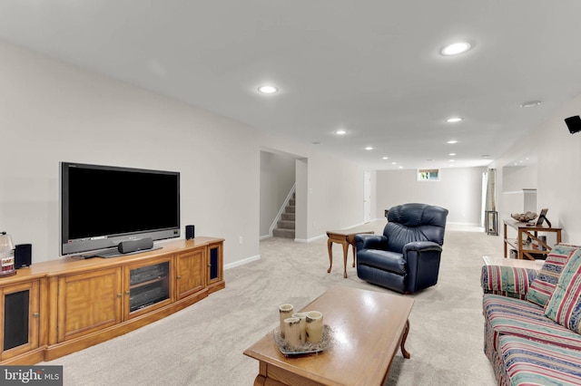 living room with recessed lighting, baseboards, light carpet, and stairway