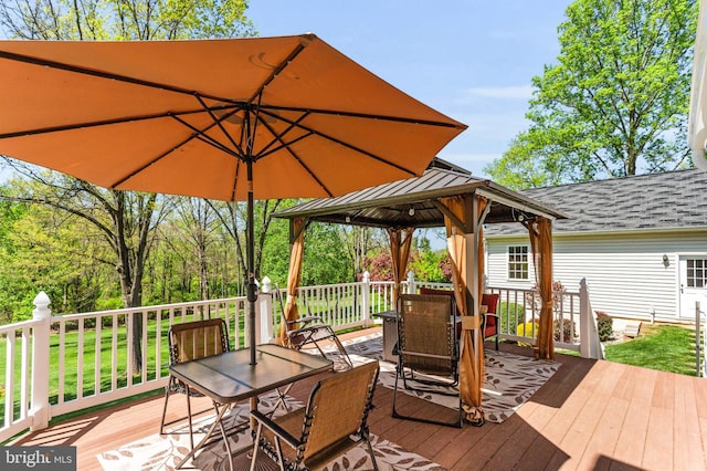 wooden deck with a gazebo and outdoor dining area