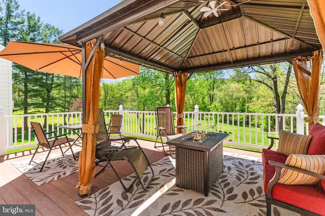 deck with a lawn, a gazebo, and an outdoor fire pit