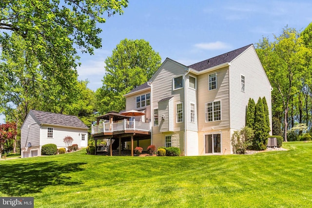 back of property featuring central AC unit, a yard, and a deck