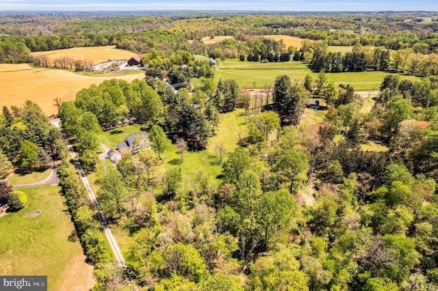 birds eye view of property featuring a wooded view