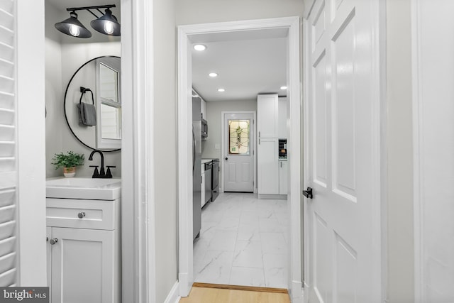 3500 The Alameda, Baltimore, MD 21218 - hallway with light marble finish flooring, a sink, recessed lighting, and baseboards