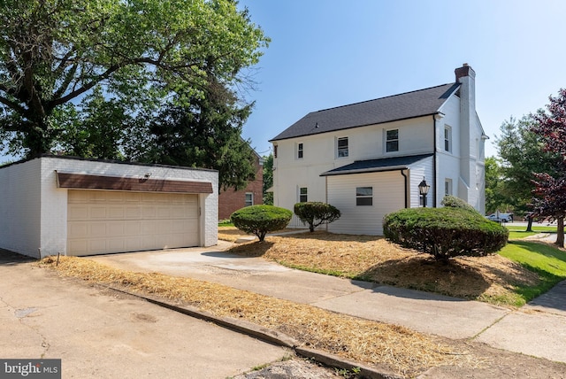 3500 The Alameda, Baltimore, MD 21218 - view of front of house with an outbuilding, a chimney, brick siding, and a detached garage