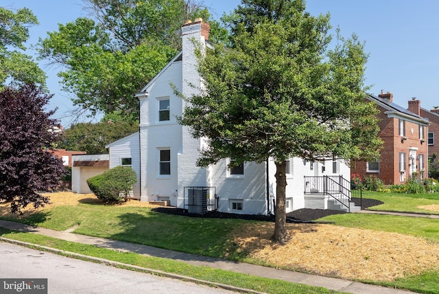 3500 The Alameda, Baltimore, MD 21218 - view of side of home featuring a chimney, brick siding, a lawn, and central AC unit