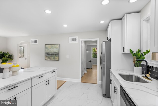 3500 The Alameda, Baltimore, MD 21218 - kitchen featuring a sink, appliances with stainless steel finishes, arched walkways, white cabinetry, and recessed lighting