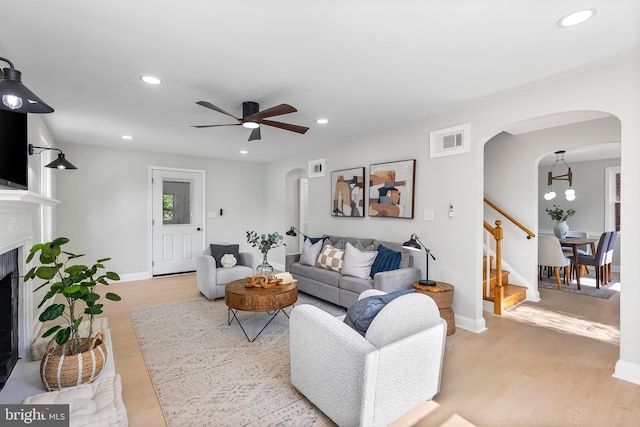 3500 The Alameda, Baltimore, MD 21218 - living room with arched walkways, a ceiling fan, light wood-style floors, stairway, and recessed lighting