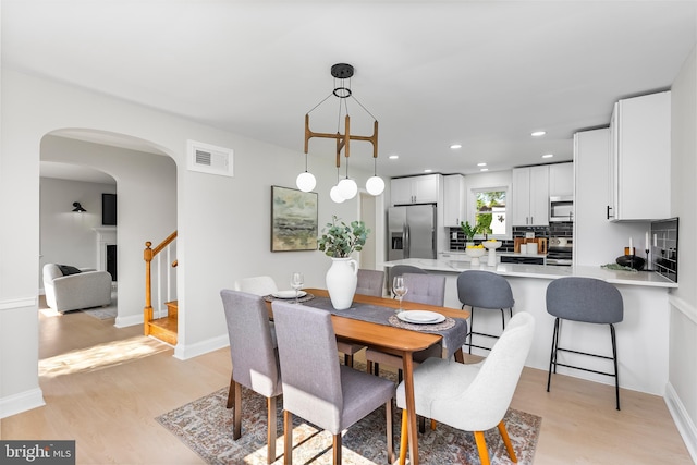 3500 The Alameda, Baltimore, MD 21218 - dining space with light wood-style floors, arched walkways, stairway, recessed lighting, and baseboards