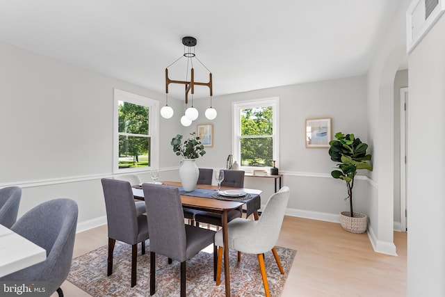 3500 The Alameda, Baltimore, MD 21218 - dining space featuring light wood finished floors, arched walkways, and baseboards