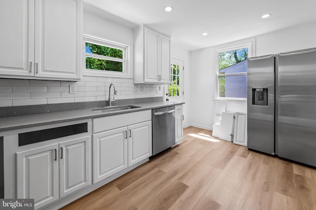 kitchen featuring a sink, white cabinetry, appliances with stainless steel finishes, and dark countertops