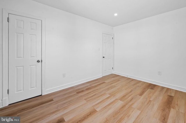 unfurnished room with recessed lighting, baseboards, and wood finished floors