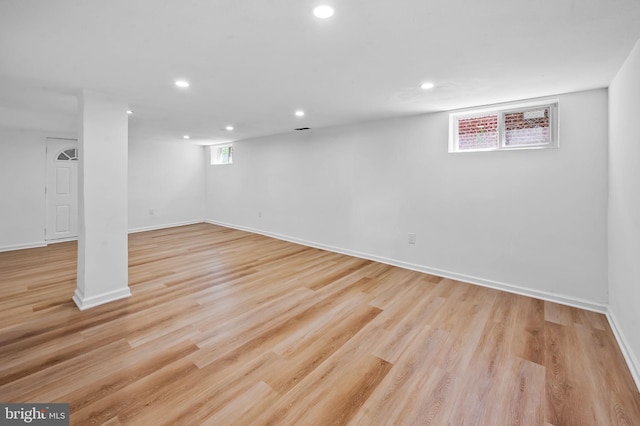 below grade area featuring light wood-style floors, baseboards, and recessed lighting