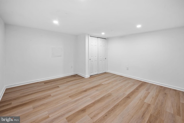 finished basement with recessed lighting, baseboards, and wood finished floors