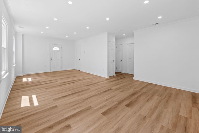 unfurnished living room with visible vents, light wood-type flooring, baseboards, ornamental molding, and recessed lighting