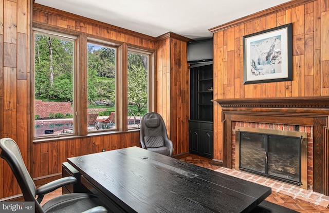 office featuring a fireplace and wood walls