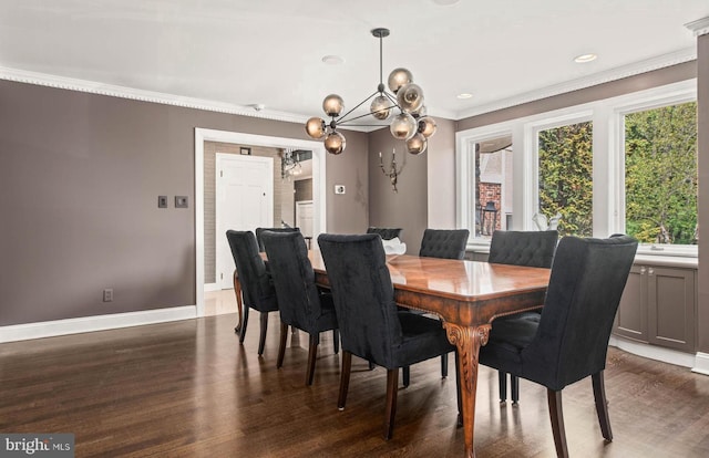 dining space with crown molding, dark wood-style flooring, baseboards, recessed lighting, and a notable chandelier