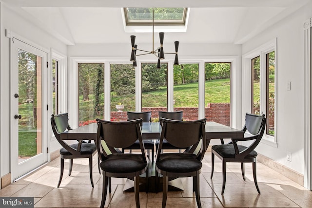 sunroom / solarium with a skylight, a chandelier, and french doors