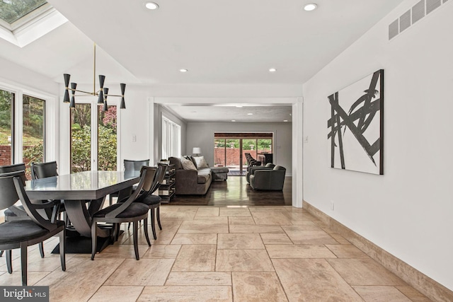 dining space with visible vents, baseboards, stone tile flooring, a chandelier, and recessed lighting