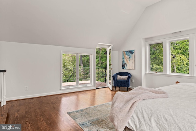 bedroom with access to outside, baseboards, vaulted ceiling, and wood finished floors