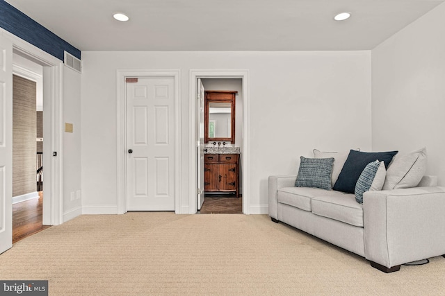 living area with carpet flooring, recessed lighting, and baseboards