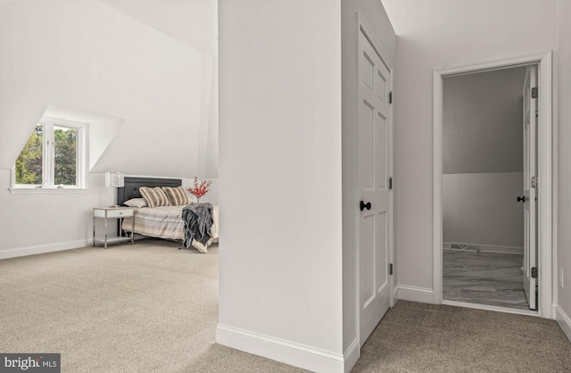 hall with baseboards and carpet