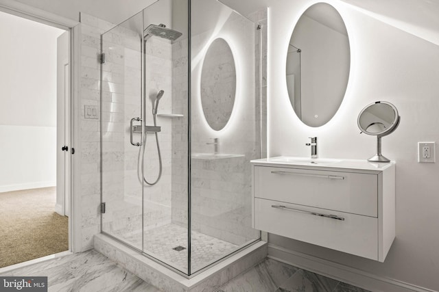 bathroom featuring vanity, baseboards, a shower stall, and marble finish floor