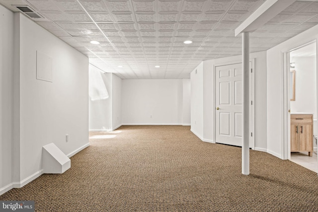 finished below grade area featuring baseboards, carpet flooring, recessed lighting, and visible vents