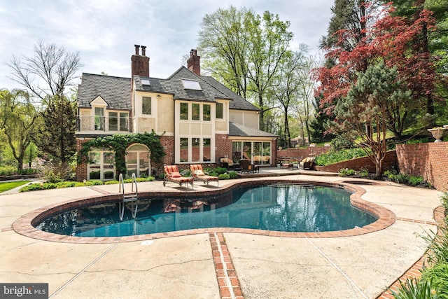 view of pool featuring a fenced in pool, fence, and a patio
