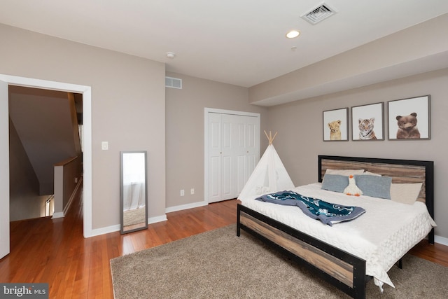 bedroom with visible vents and wood finished floors