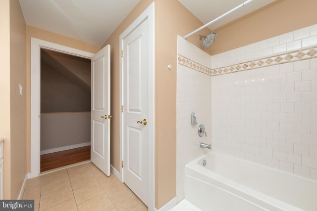 bathroom with baseboards, bathtub / shower combination, and tile patterned floors