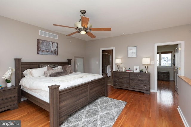 bedroom with ceiling fan, visible vents, and wood-type flooring