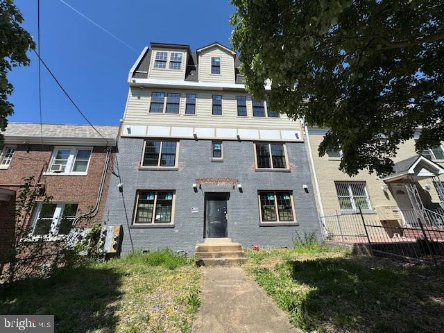 townhome / multi-family property with fence and brick siding