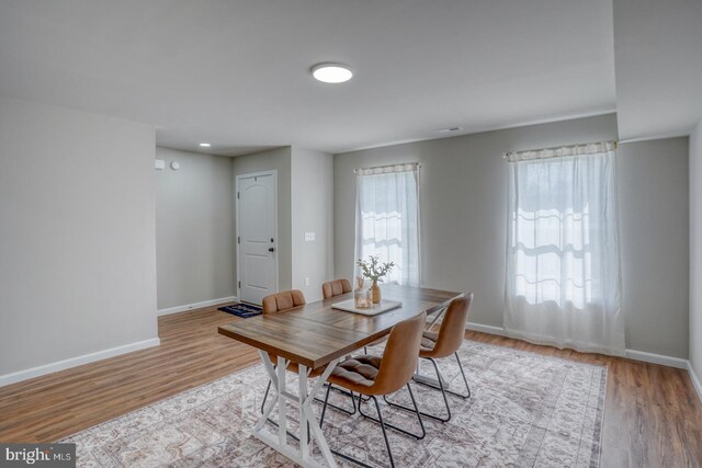 dining room with baseboards and wood finished floors