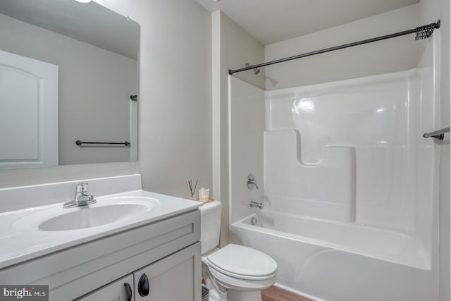 full bathroom featuring toilet, shower / bath combination, wood finished floors, and vanity